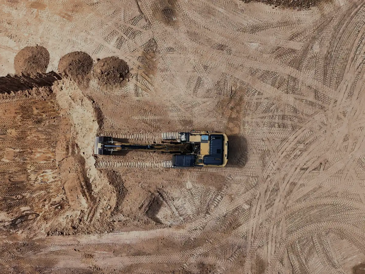 Aerial view of an excavator working on an earthmoving site